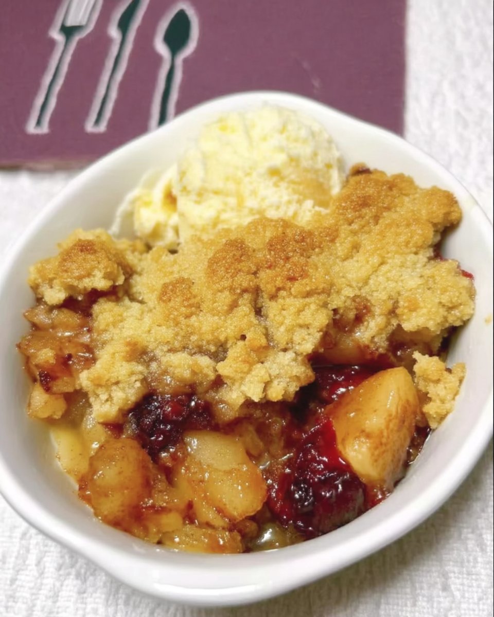 Slice of apple cranberry dump cake on a white plate