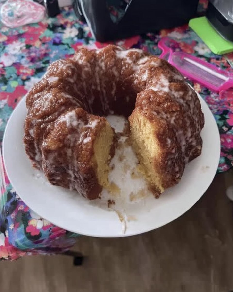 Slice of fluffy buttermilk vanilla cake with chocolate frosting on a white plate