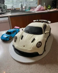 Red car shaped birthday cake with oreo wheels