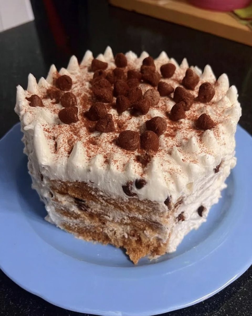 Slice of chocolate layer cake showing dark cremeux and whipped ganache layers
