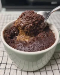 Warm chocolate mug cake with a spoon