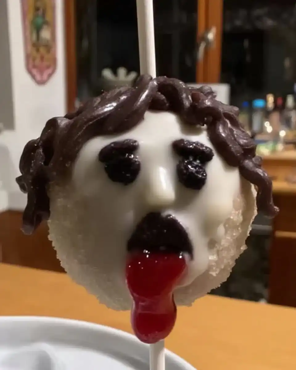 Dipping a cake ball into melted chocolate candy melts