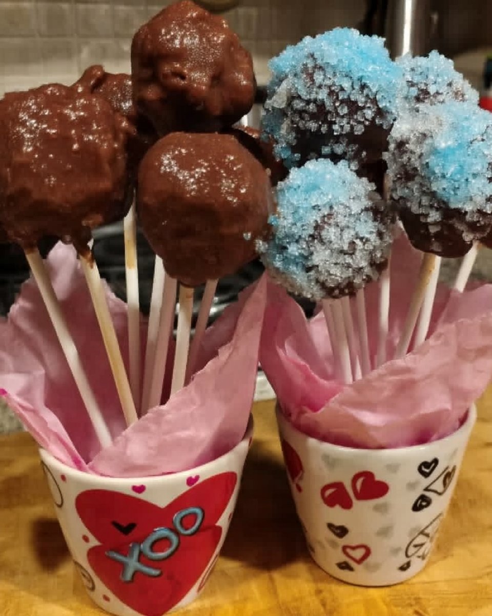 Frosted chocolate cake square served with a glass of milk