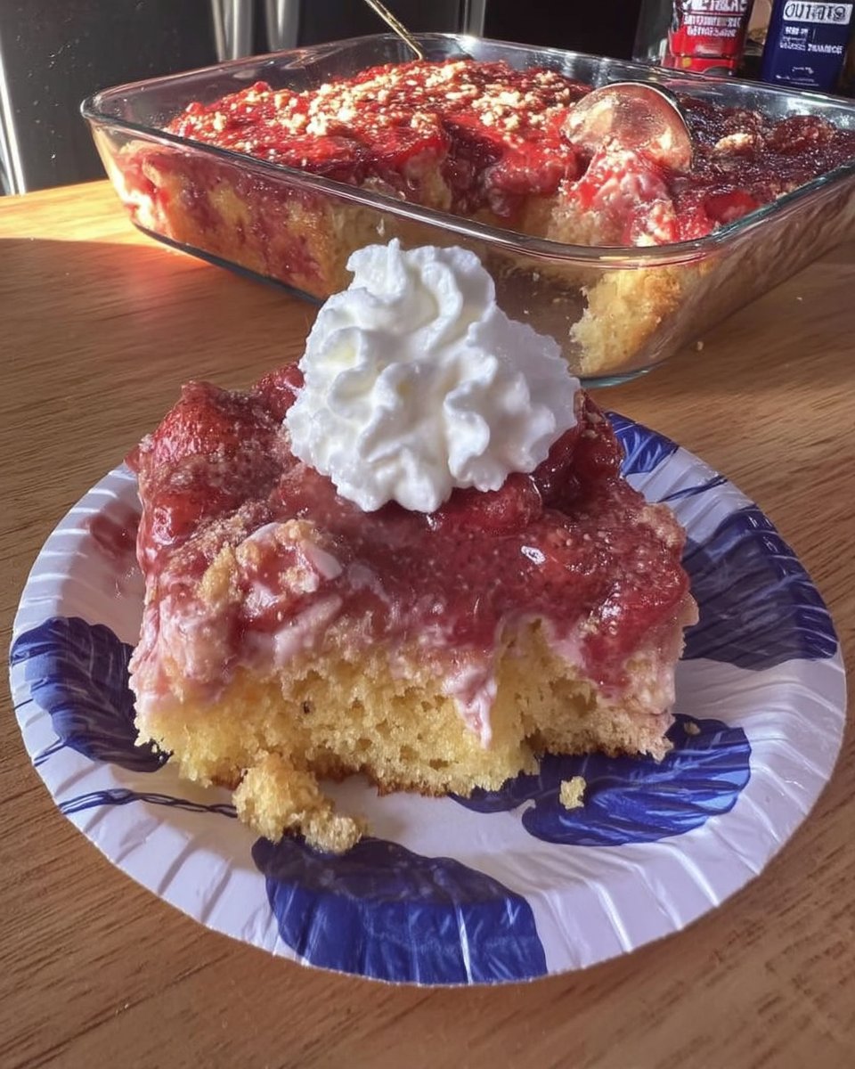 Whole strawberry sheet cake in pan topped with fresh berries