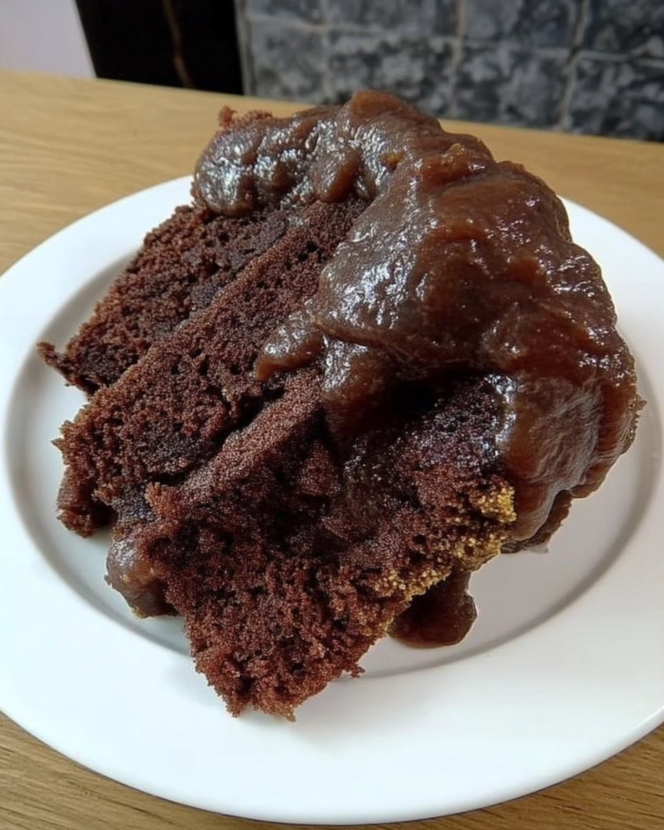 Whole chocolate bundt cake with shiny chocolate glaze dripping down sides