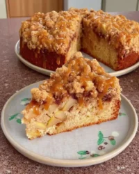 Slice of Irish apple cake with streusel topping on a plate