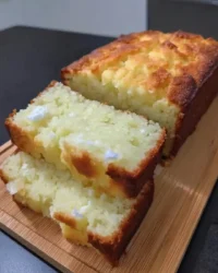 Slice of moist lemon yogurt cake on a white plate