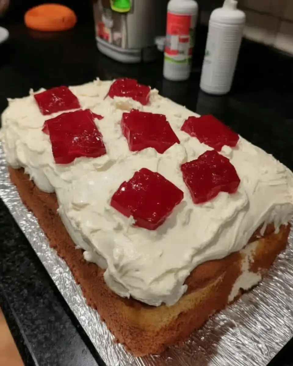 Red and white marzipan squares being prepared for cake decoration