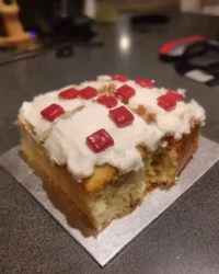 Square chocolate cake decorated with white marzipan and red specks