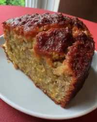 Slice of moist banana cake with thick cream cheese frosting