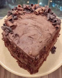 Slice of new year champagne cake with blue drip and white frosting