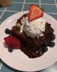 Slice of three layer Nutella cake with hazelnut pieces