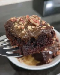 Slice of old fashioned chocolate cake with boiled icing on a plate