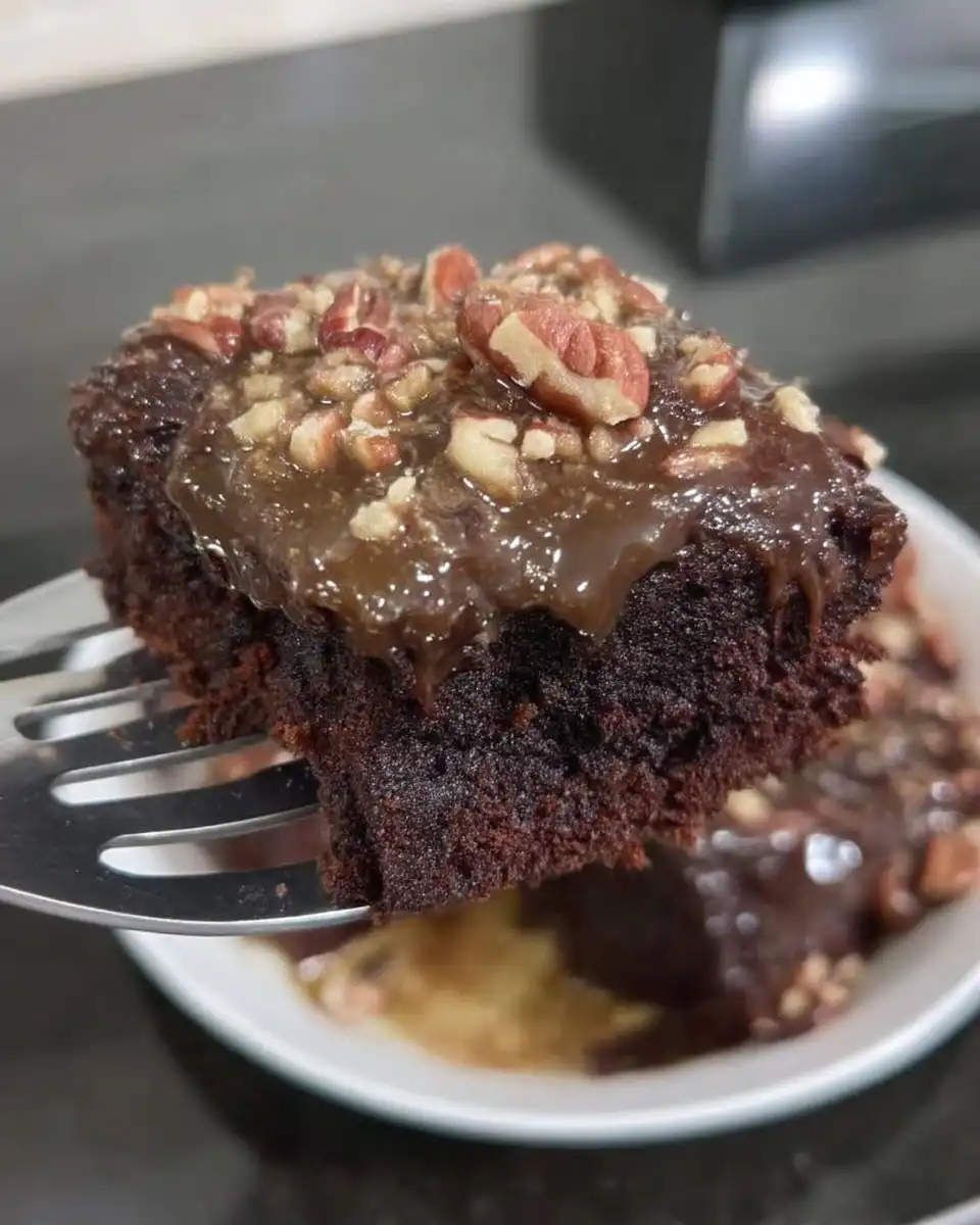 Slice of old fashioned chocolate cake with boiled icing on a plate