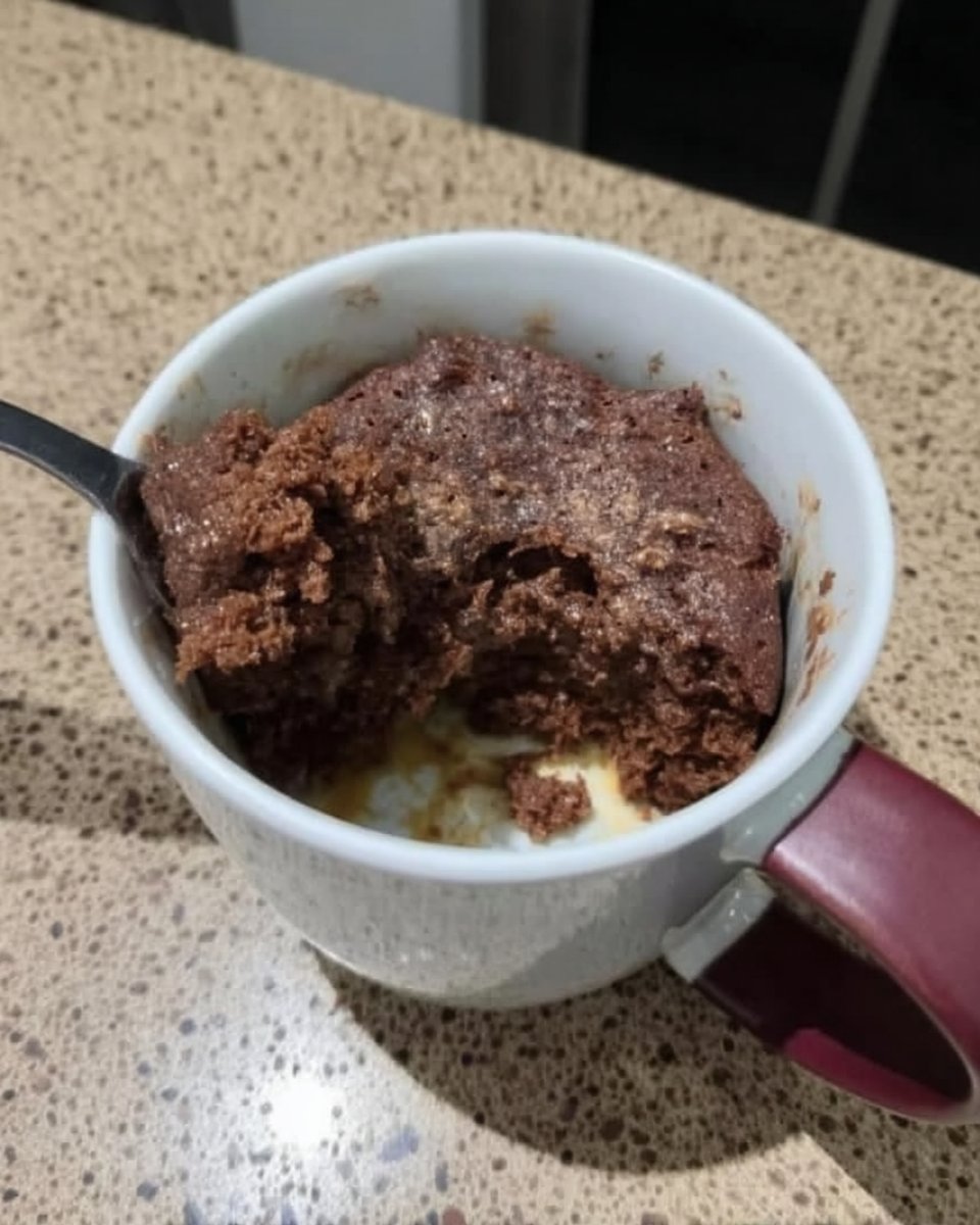 Piping bag applying Nutella buttercream to chocolate sponge