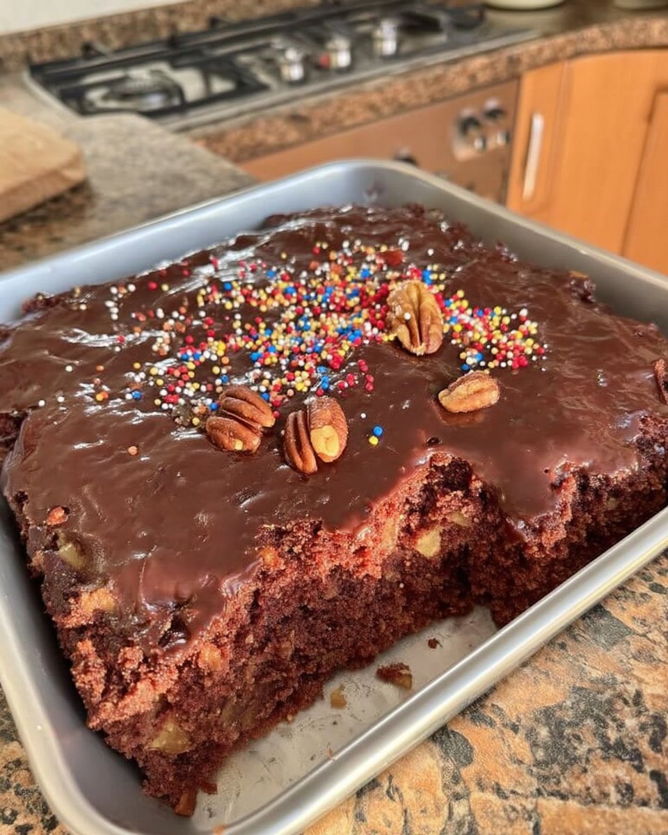 Pouring warm chocolate pecan icing over a sheet cake