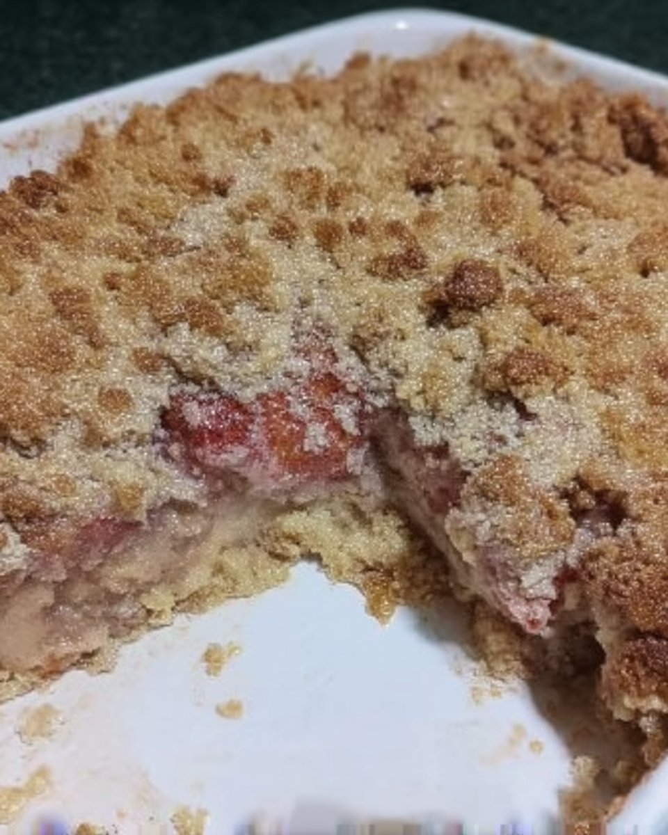 Strawberry Rhubarb Cake 13 Pouring milk glaze over a baked cake in a pan