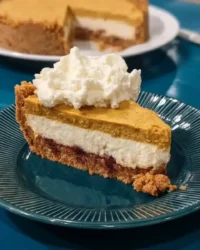 Whole no-bake pumpkin cheesecake with whipped cream and gingersnap crust