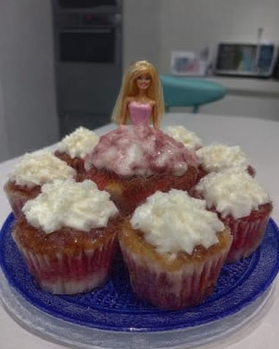 Green marzipan being rolled out on a white surface