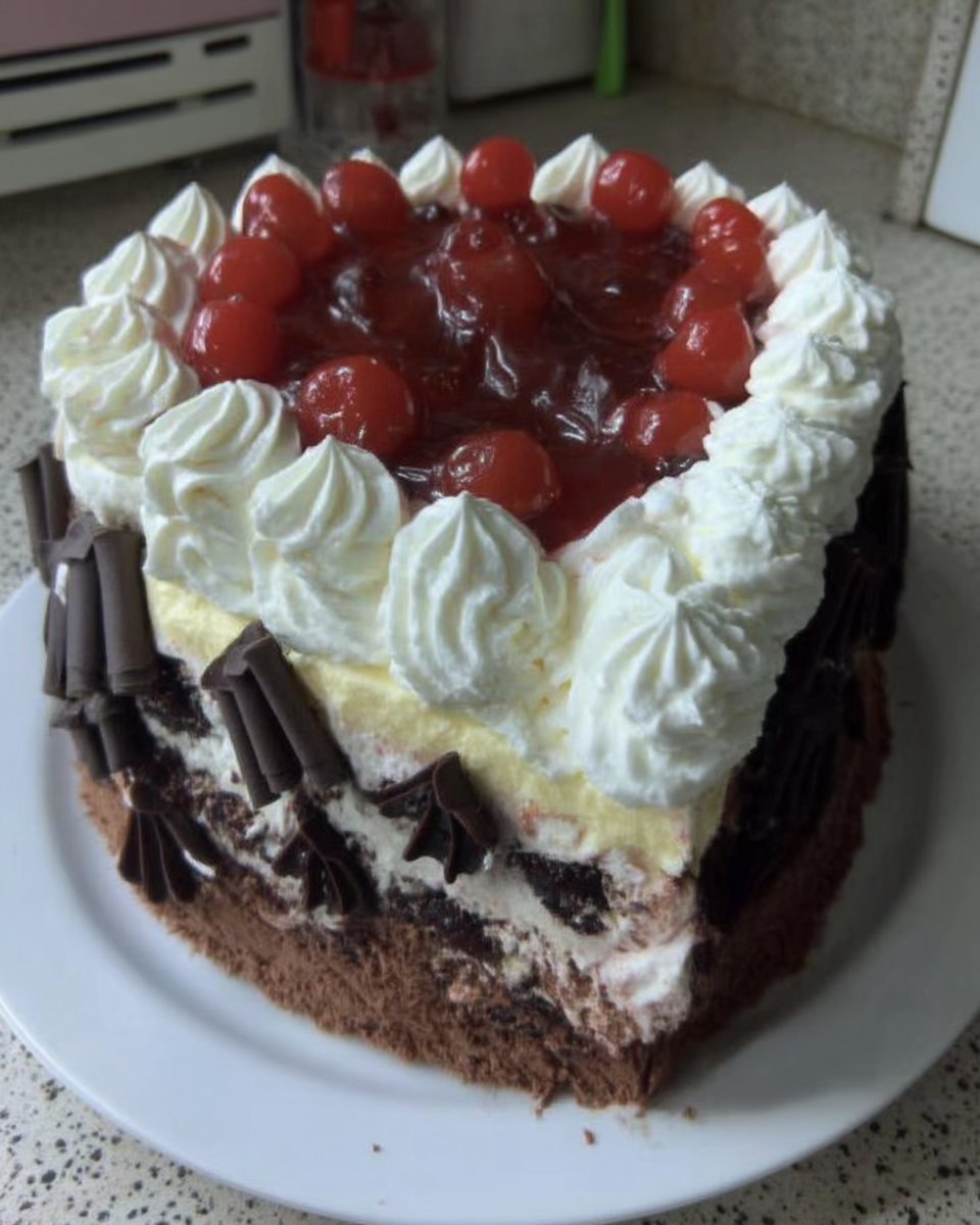 Black Forest Cake 14 Whole black forest cake served with a cup of coffee