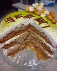 A slice of moist green cake on a plate with cream cheese frosting