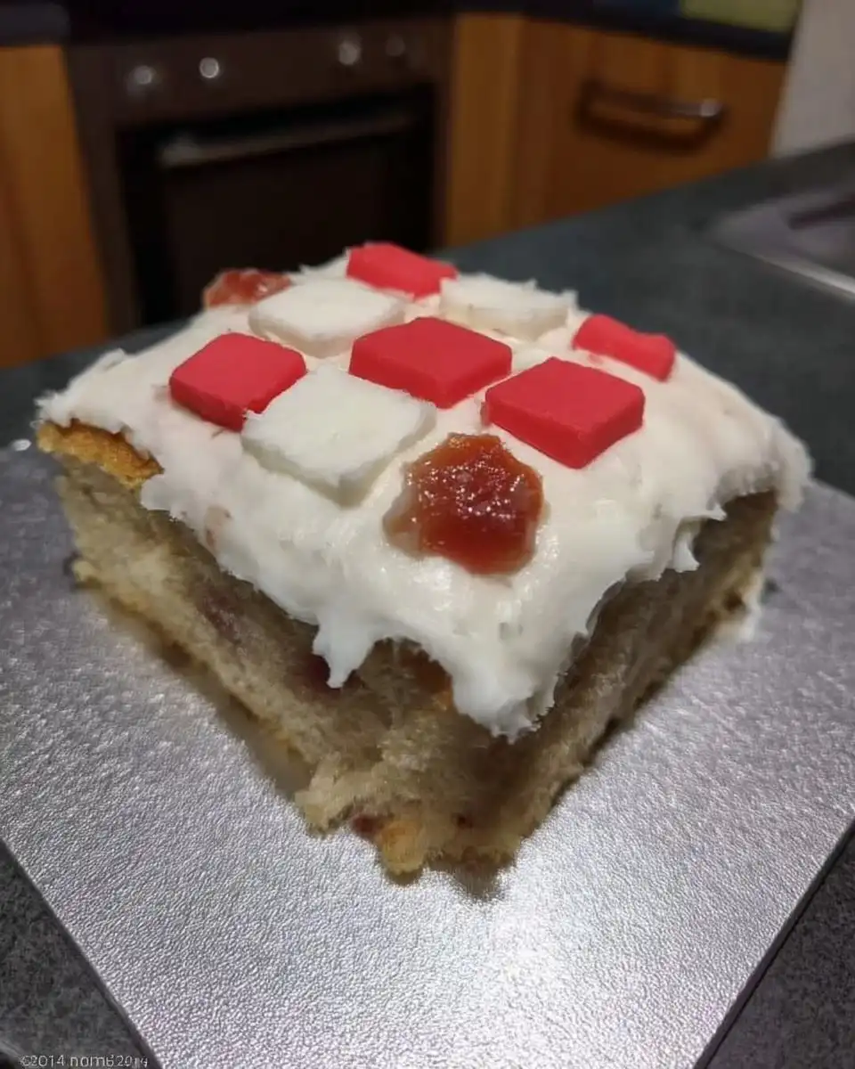 Slice of chocolate cake with cherry filling and marzipan topping