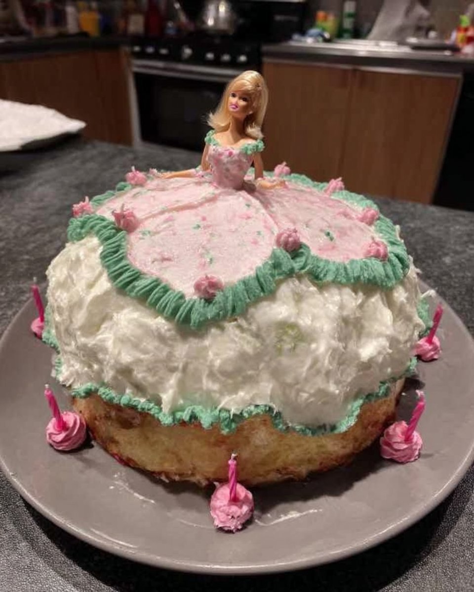 Slice of yellow cake with pink frosting from the barbie cake