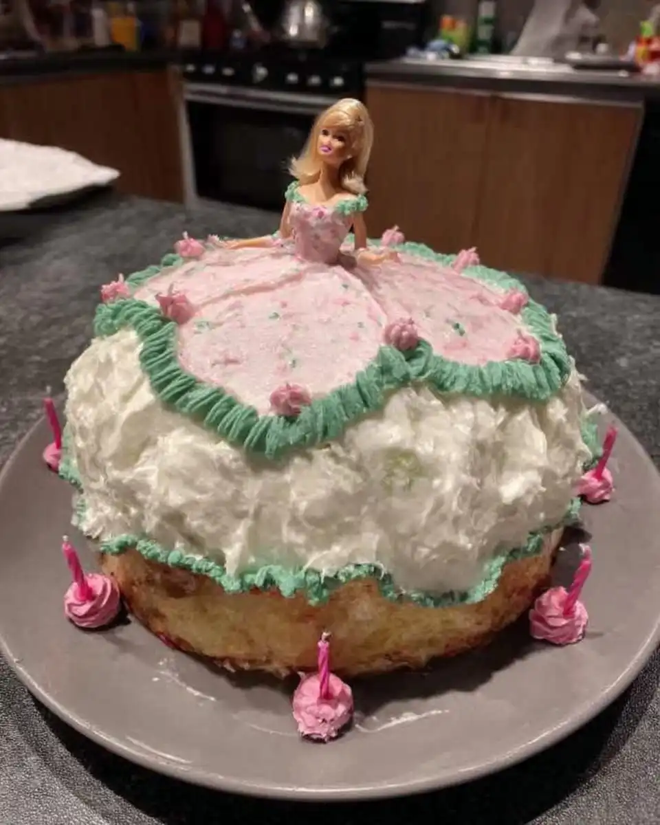 Slice of yellow cake with pink frosting from the barbie cake