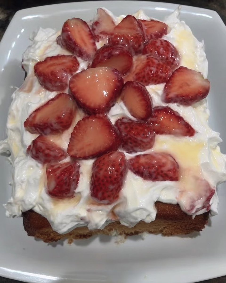 Slice of strawberry poke cake on a white plate