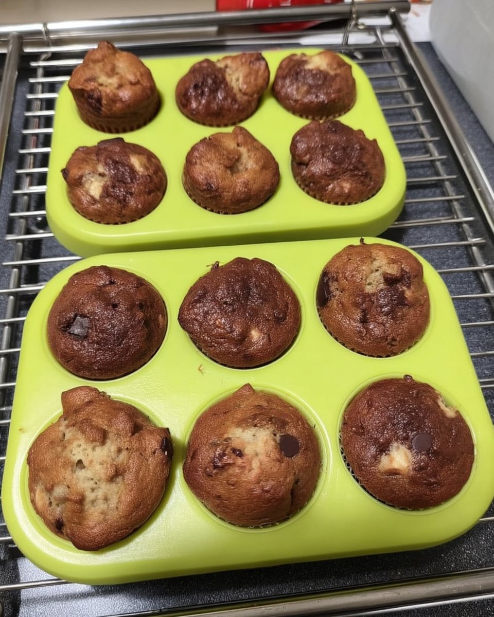 Golden vanilla mini cakes sitting on a cooling rack