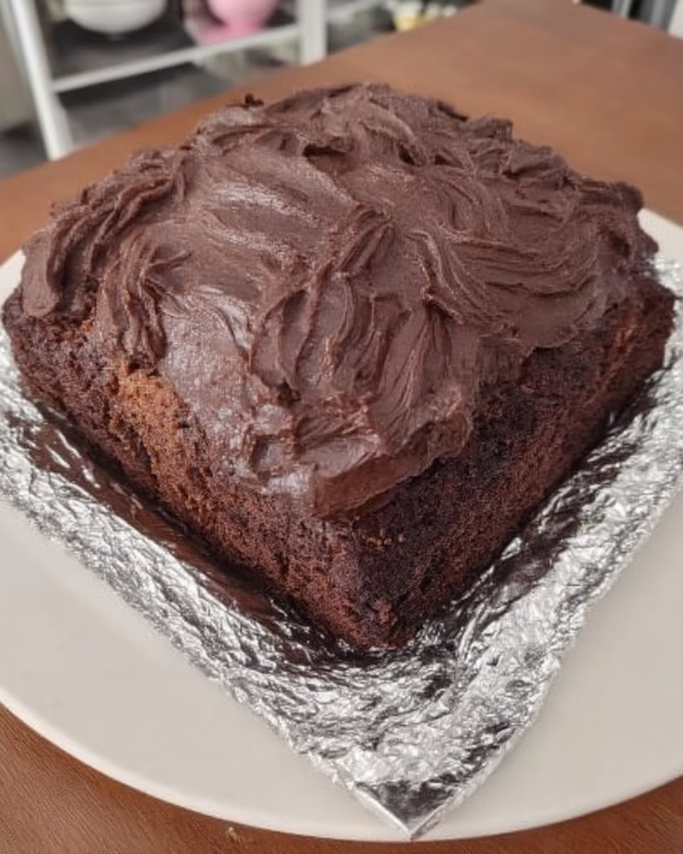 Slice of moist wacky cake on a white plate