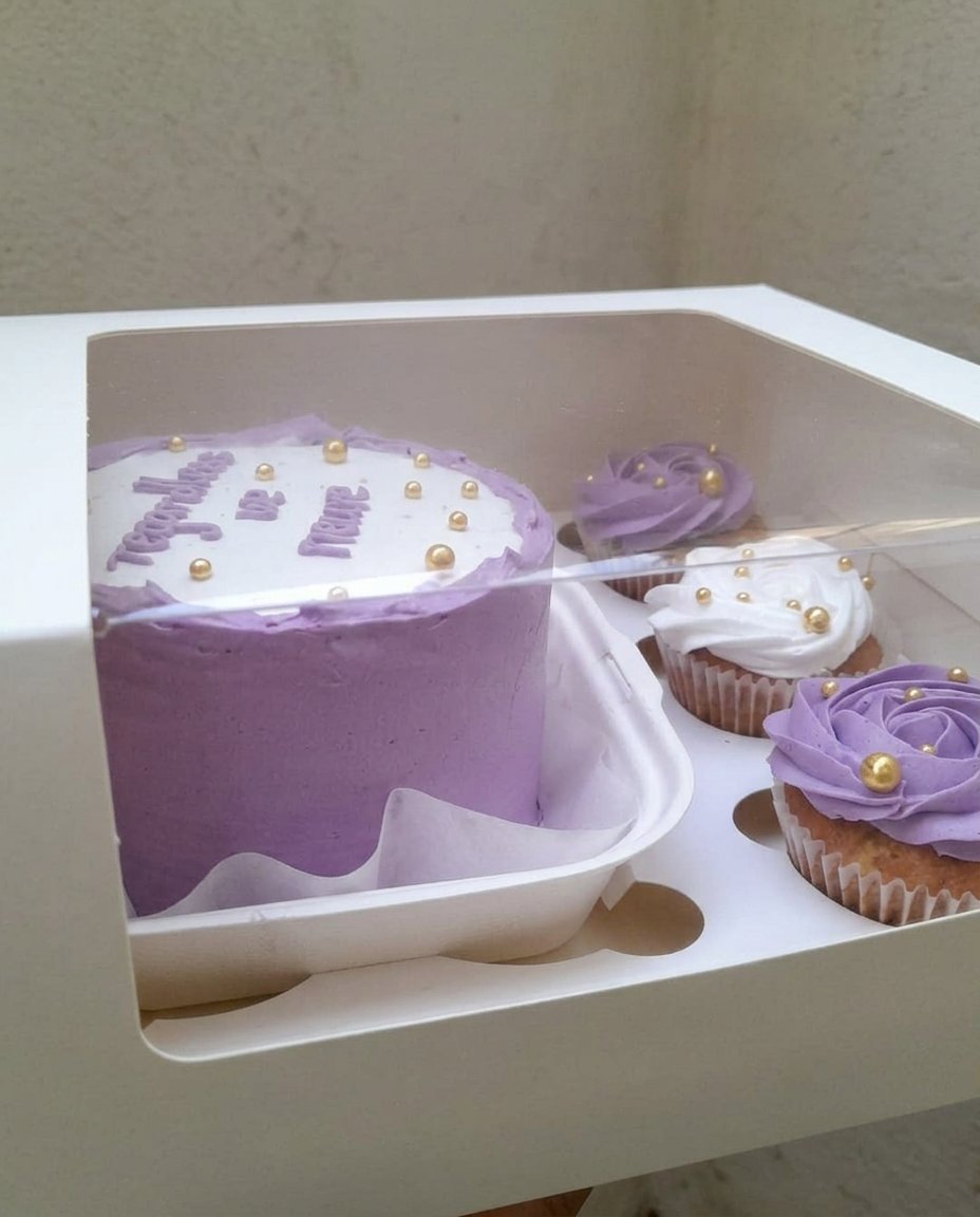 A finished cake bento decorated with small edible flowers and sprinkles