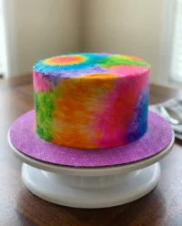 A simple white cake with delicate painted floral designs