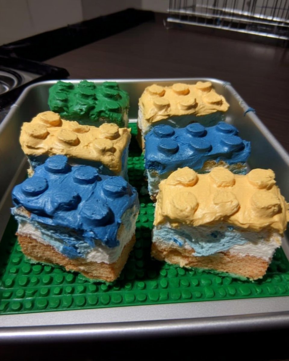 Decorating small cake rectangles with colorful icing and candies