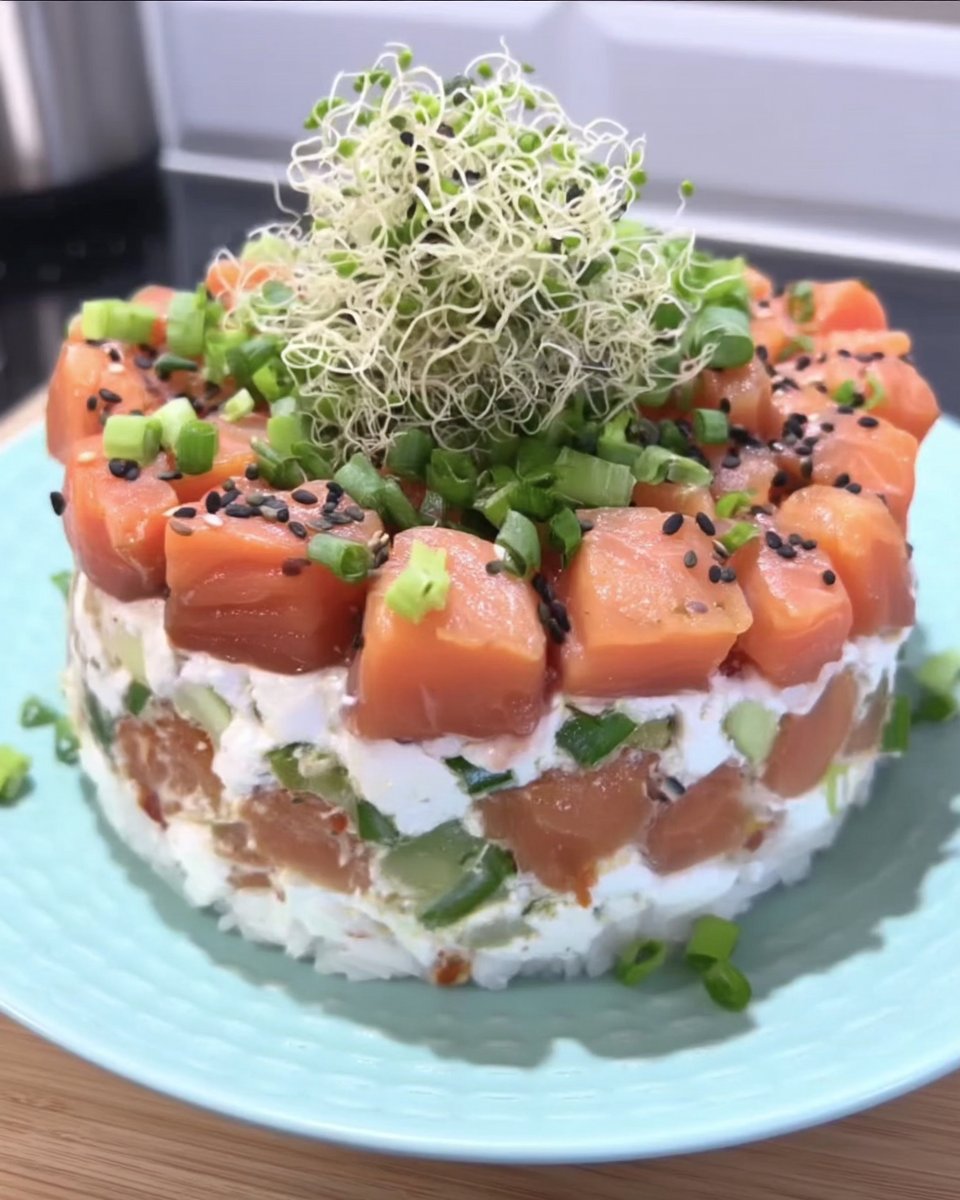 A beautiful layered sushi cake with salmon and avocado