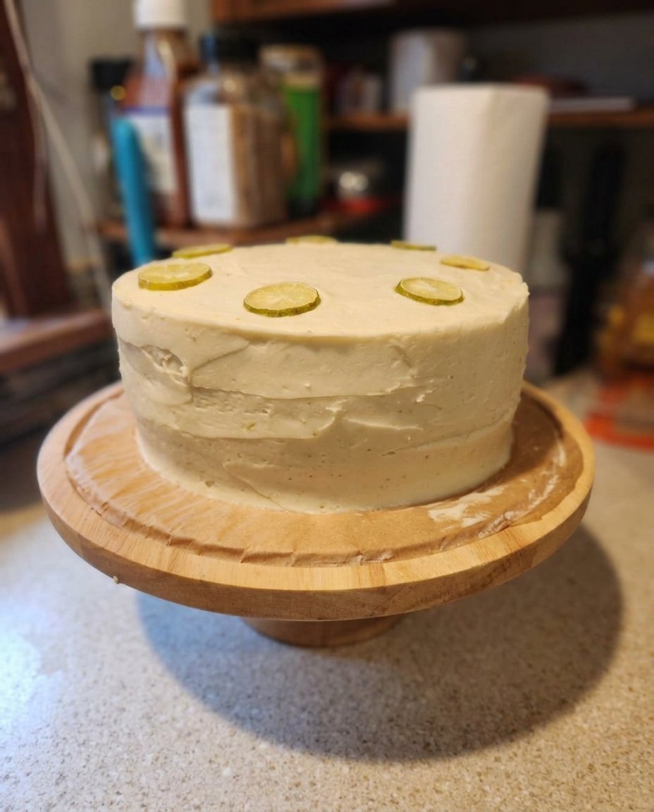 Fresh limes, flour, butter and sour cream on a wooden kitchen counter