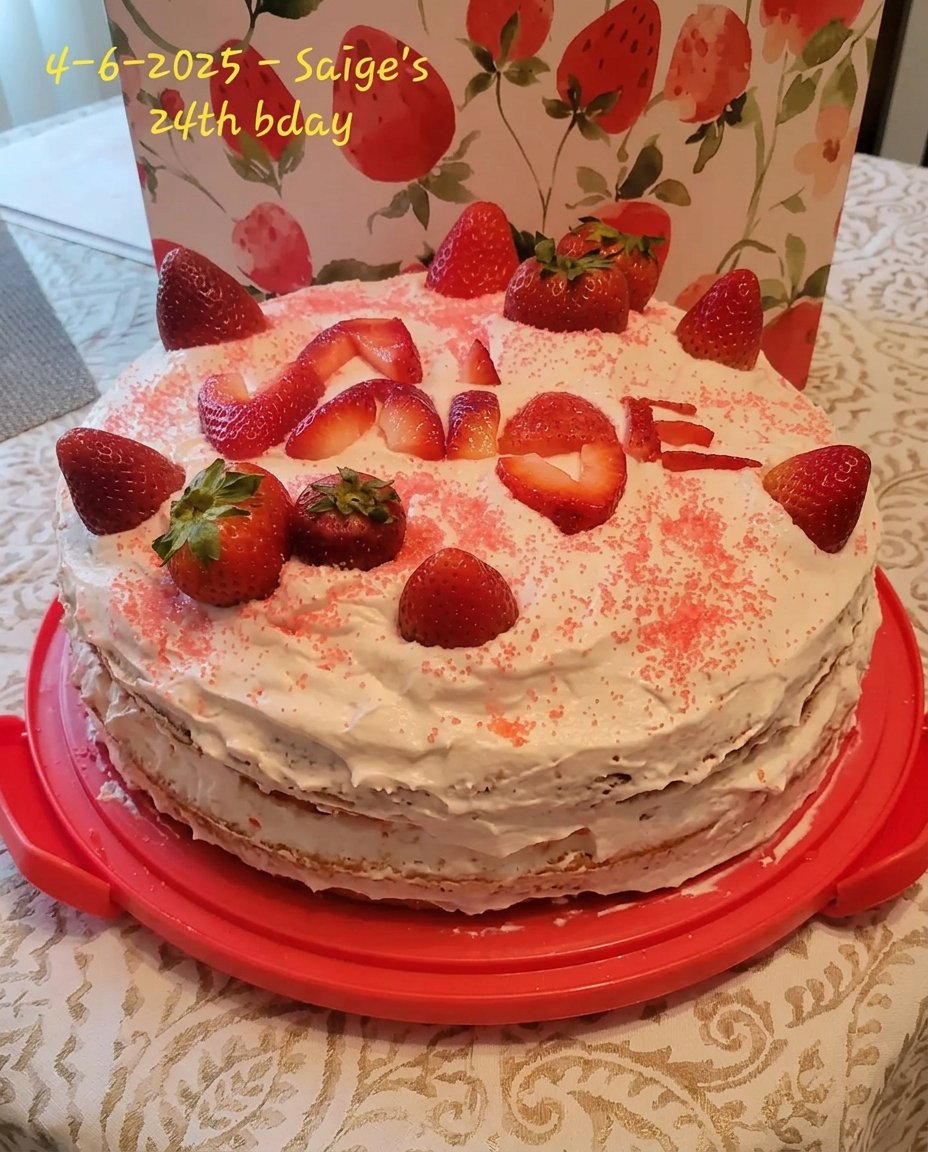 A bowl of fresh strawberries next to a lemon and a small pile of lemon zest.