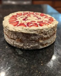 A fresh strawberry icebox cake being prepared in a loaf pan