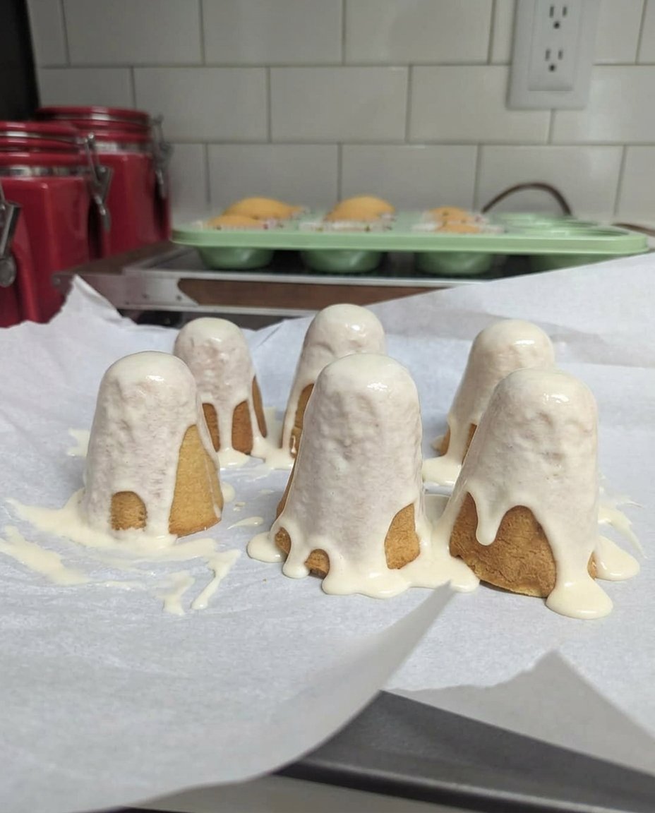 Ghost cake served on a dark plate with Halloween decorations nearby