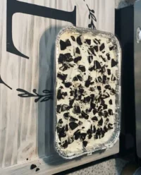 A giant golden brown cookie cake loaded with dark chocolate chunks and pecans