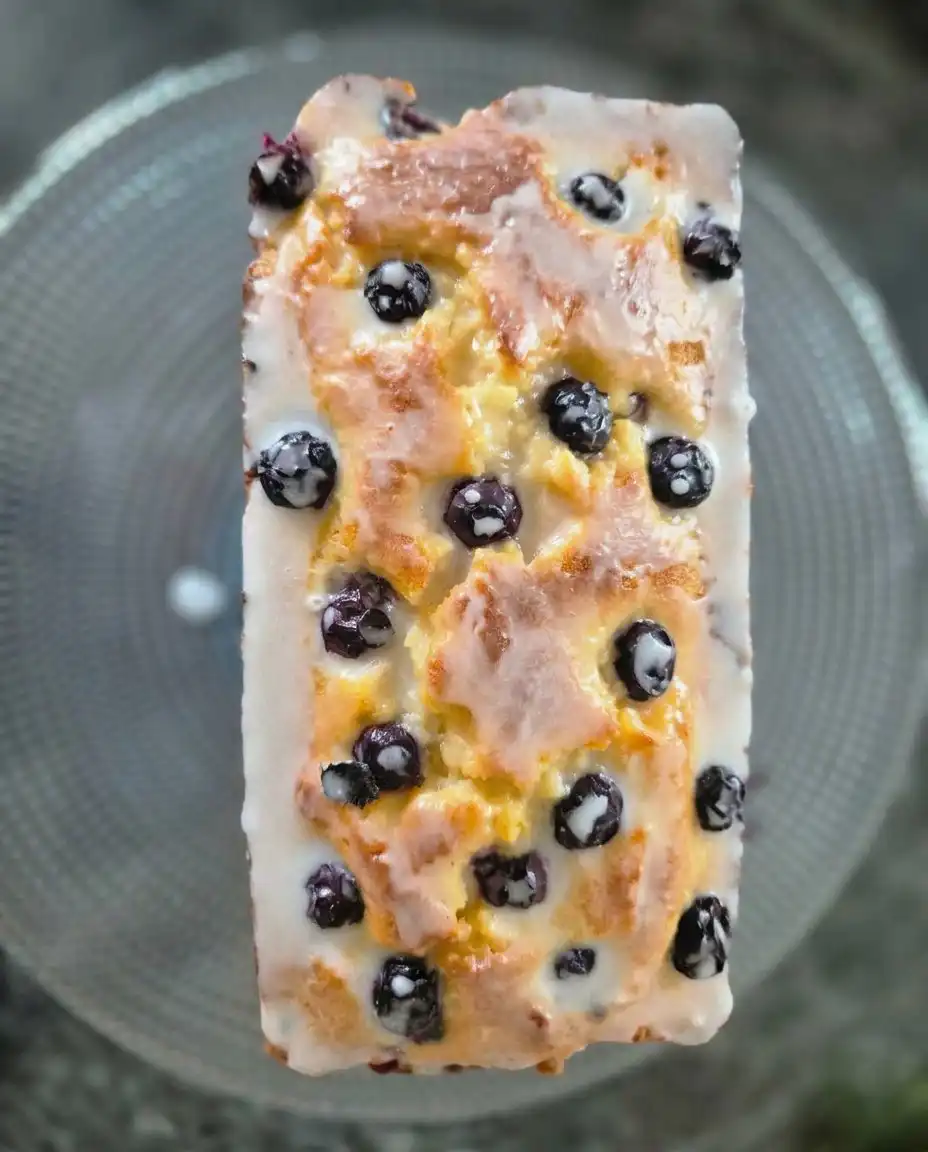 Pantry staples like flour, sugar, lemons, and fresh blueberries on a kitchen counter