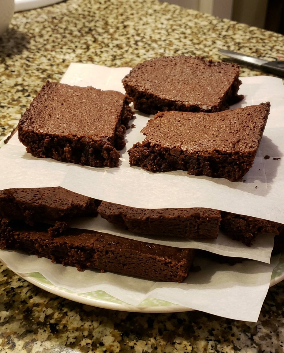 A bowl of melted chocolate and butter being stirred together