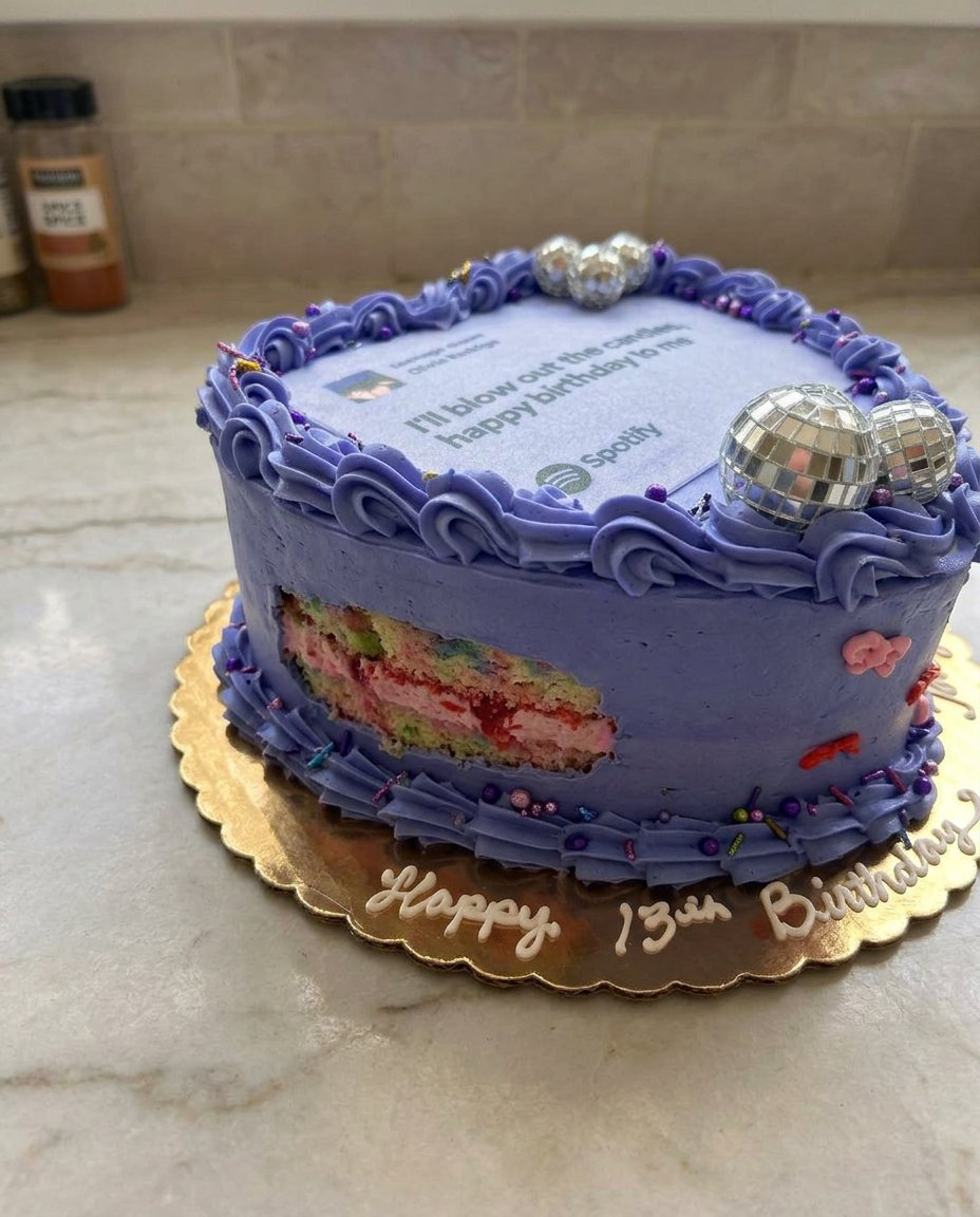 A four layer purple Olivia Rodrigo cake with vintage piping and bows