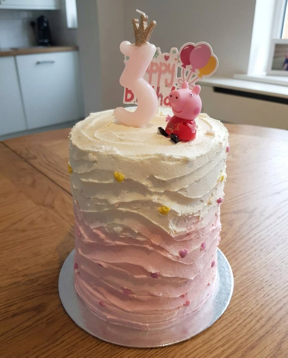 Piping pink buttercream rosettes onto a dress shaped cake.