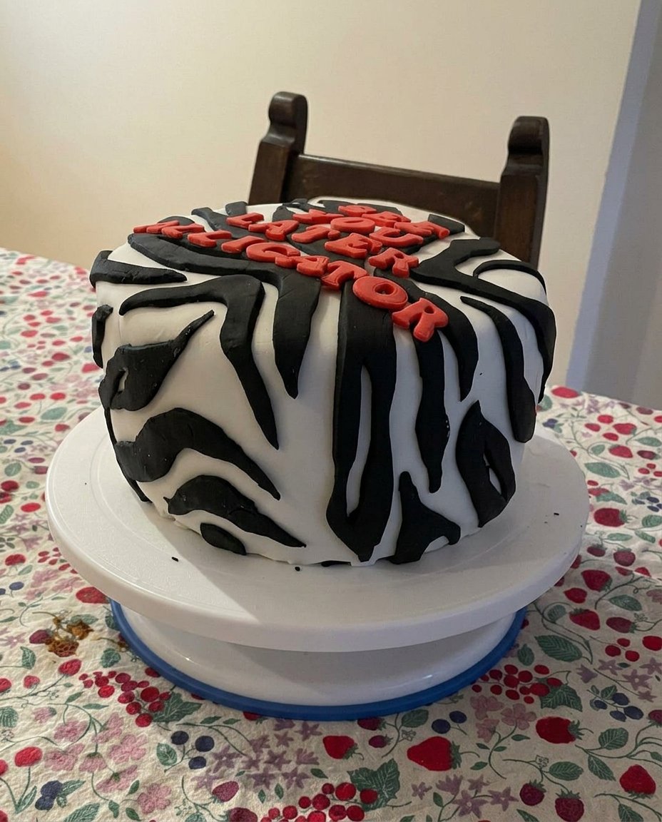 A slice of aesthetic yellow cake with chocolate frosting on a white plate