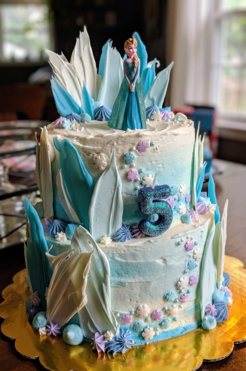 A slice of Frozen Cake served on a plate with coconut snow garnish.