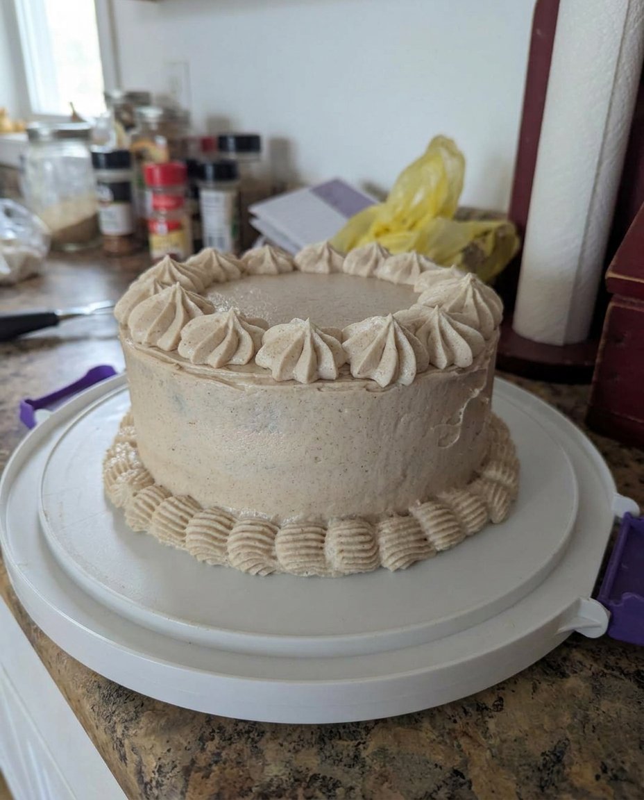 A moist chocolate poke cake topped with whipped cream and Snickers pieces