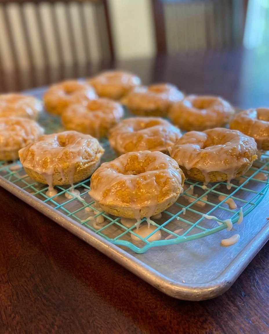 A freshly baked chocolate donut cake resting on a wire cooling rack