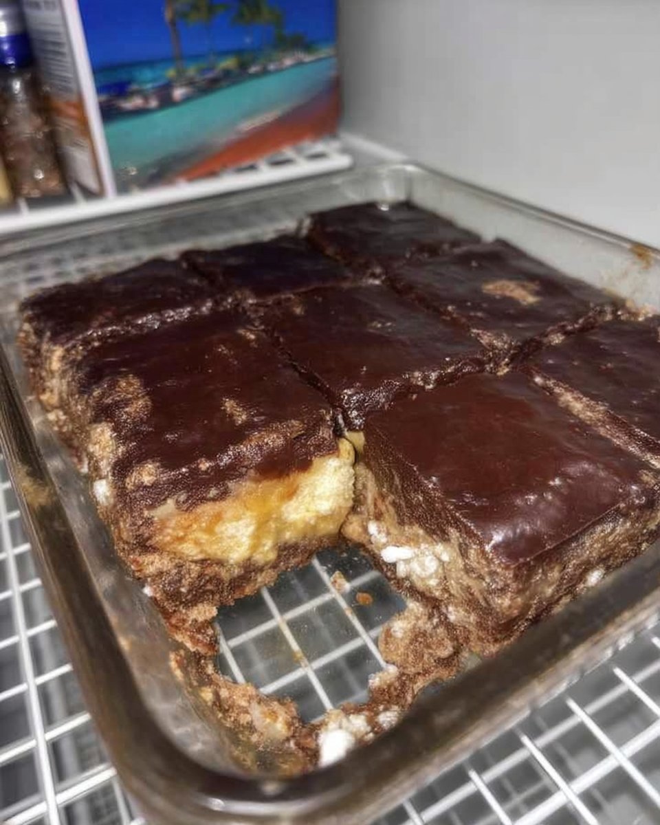 A single slice of chocolate eclair cake showing the creamy layers