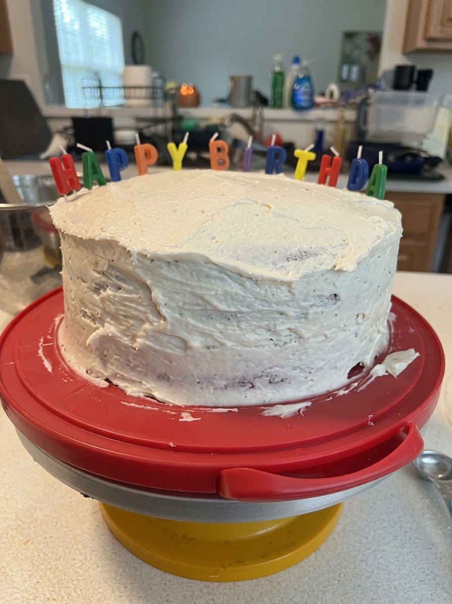 Red Cake 14 A single slice of red cake with pecans on a white plate with a fork